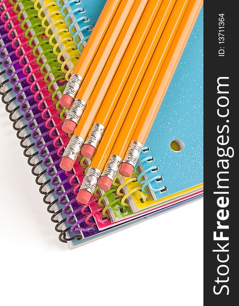 Pencil and colorful notebooks on white. Pencil and colorful notebooks on white