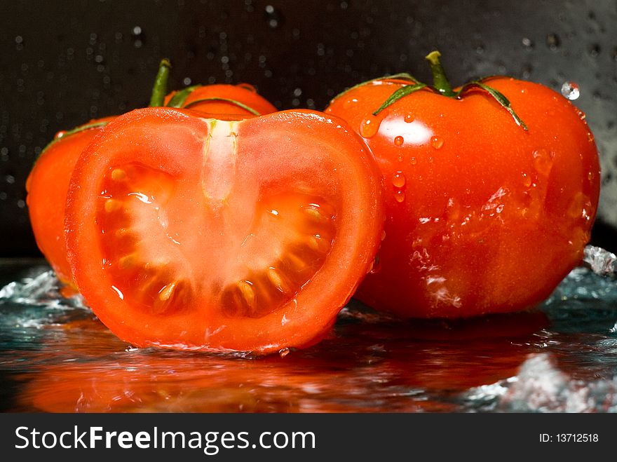 Pouring water on ripe tomatoes. Pouring water on ripe tomatoes