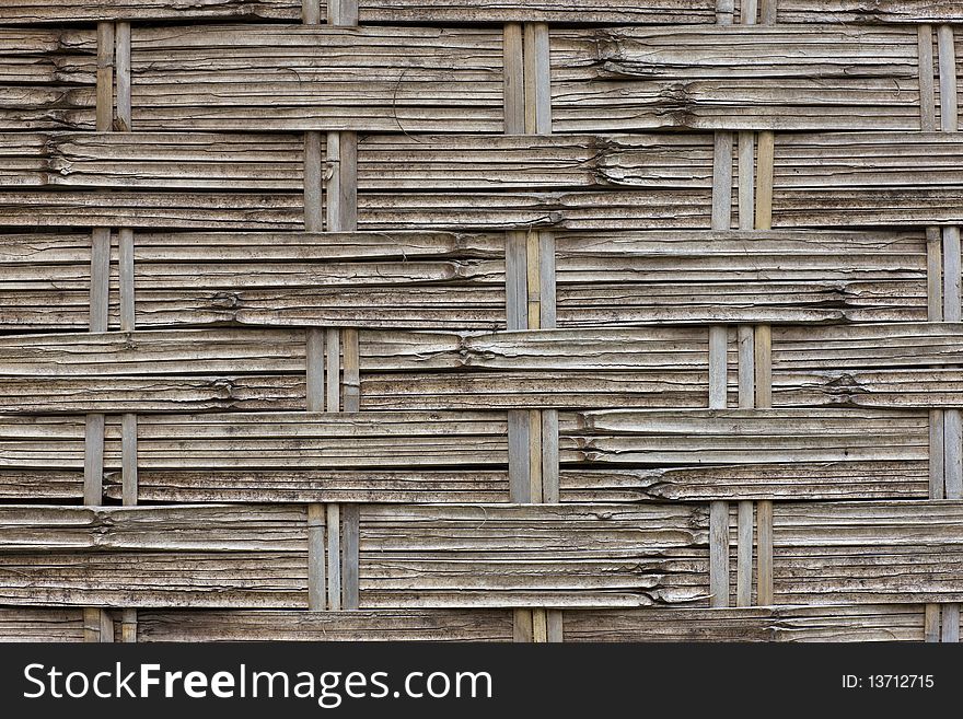 Closeup of a bamboo mat showcasing its woven strands. Horizontal shot. Closeup of a bamboo mat showcasing its woven strands. Horizontal shot.