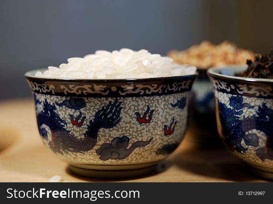 Rice, buckwheat and black leaf tea in Chinese cups. Rice, buckwheat and black leaf tea in Chinese cups