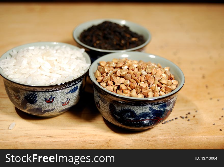 Rice, buckwheat and black leaf tea in Chinese cups. Rice, buckwheat and black leaf tea in Chinese cups