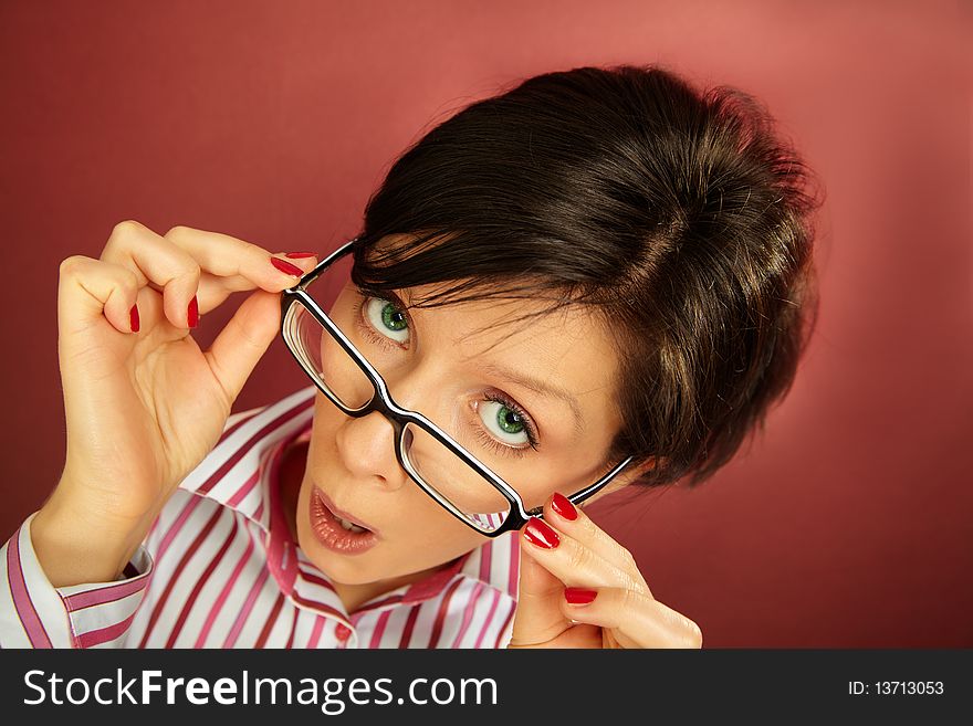 Caucasian woman in glasses is making faces