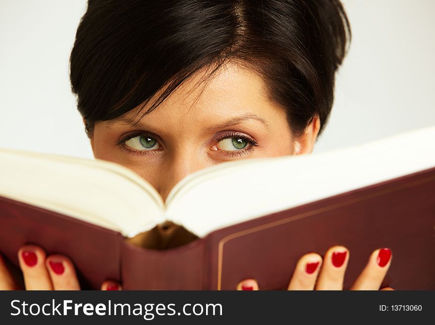 Caucasian woman is holding book and thinking. Caucasian woman is holding book and thinking