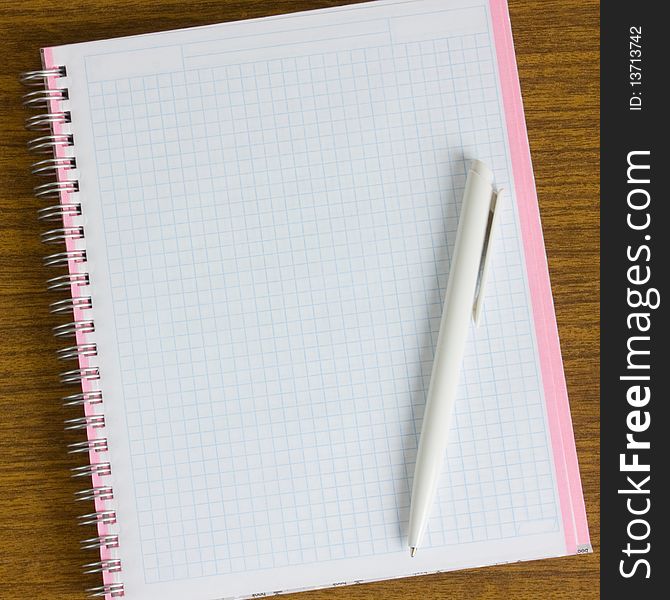 Notebook and pen on a wooden table