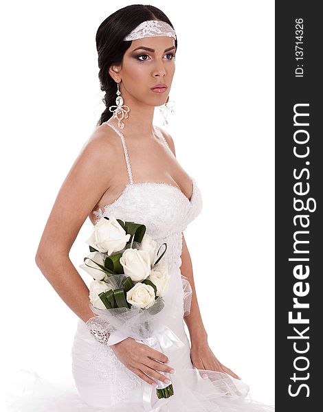 Young beautiful bride with bouquet of roses in white background