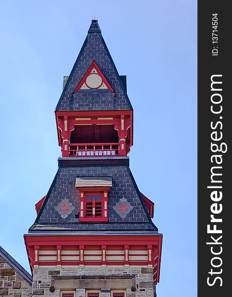 Close-up detail of a building's steeple against a bright, blue sky. Close-up detail of a building's steeple against a bright, blue sky.