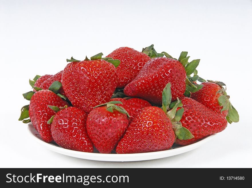 Plate of strawberries on white background