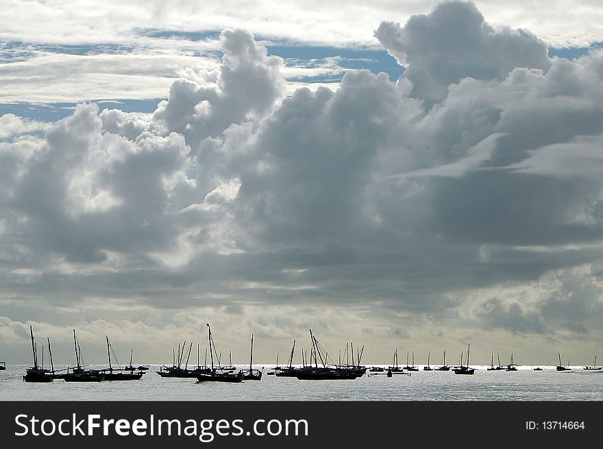 Dhow gathered off of the shore of Zanzibar before going out to sea. Dhow gathered off of the shore of Zanzibar before going out to sea.