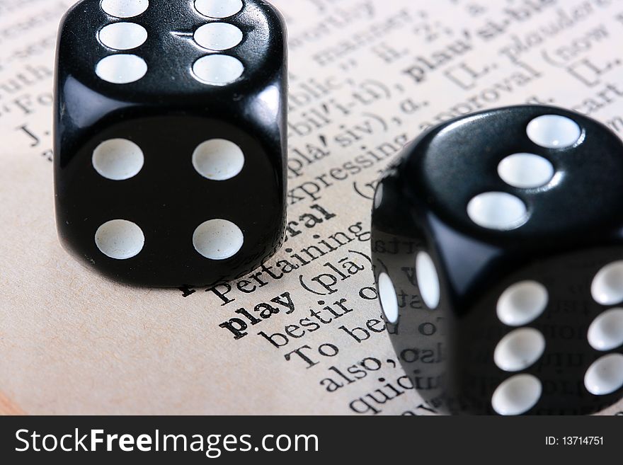Black cubes for game against the book with word Play.