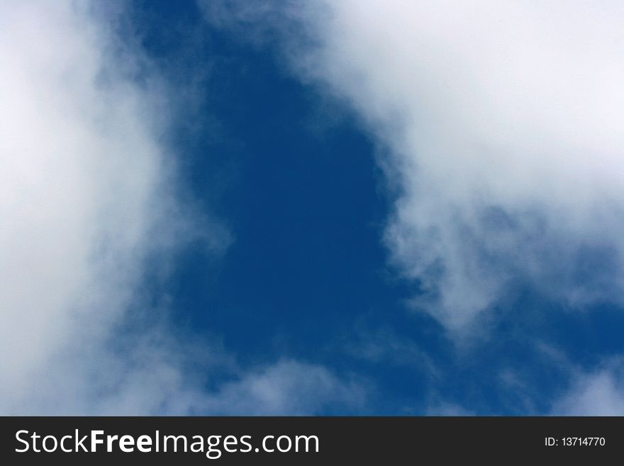 The dark blue sky in the afternoon with clouds as a background for design works.