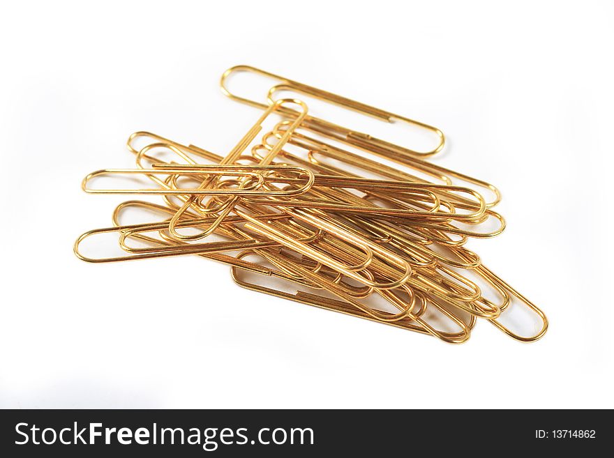 Gold paper clips on a white background