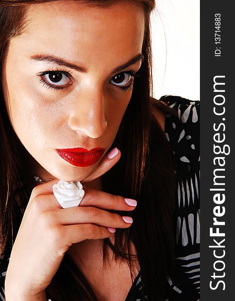 Closeup of the face of a lovely woman with red lips and a big white
ring on her finger, in a black white dress for white background. Closeup of the face of a lovely woman with red lips and a big white
ring on her finger, in a black white dress for white background.