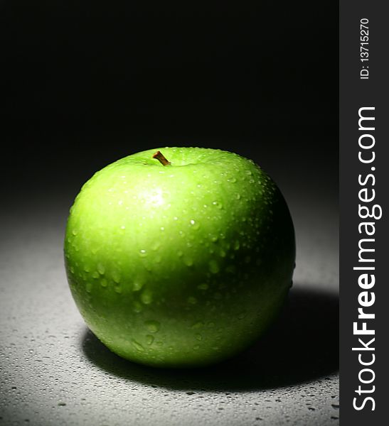 Green Apple on white background in the dark