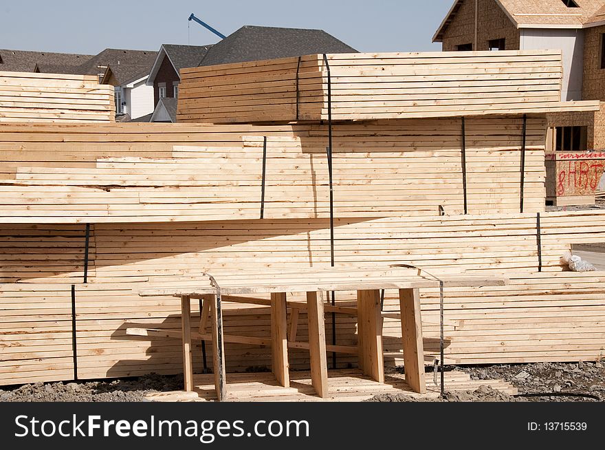 Roof trusses piled outside construction site