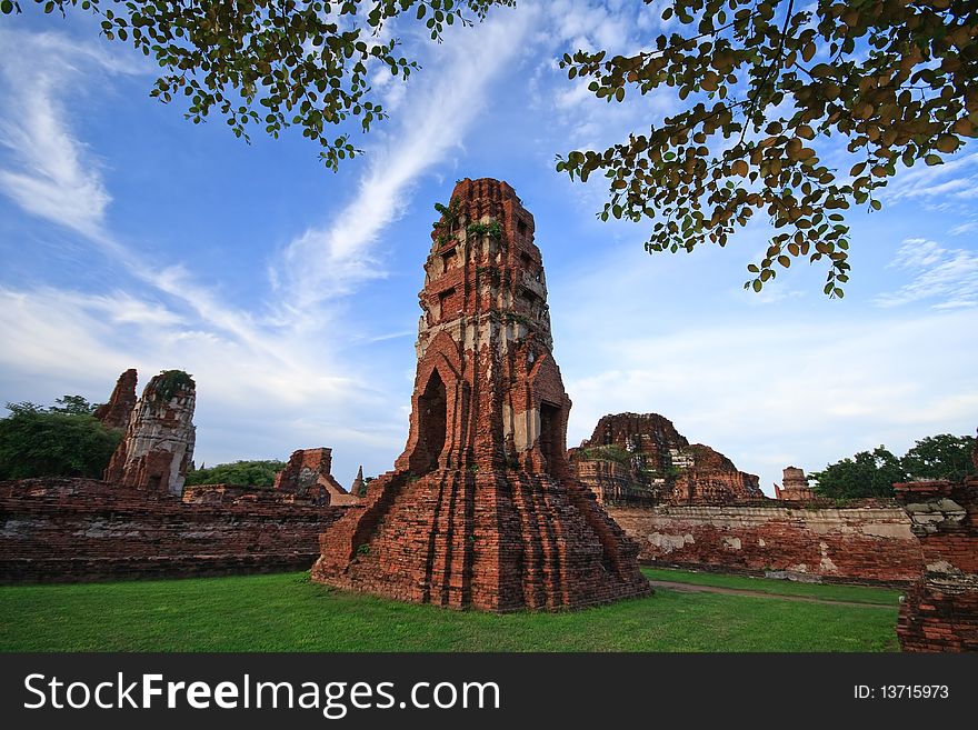 Thai Ancient Temple with blue sky, green field