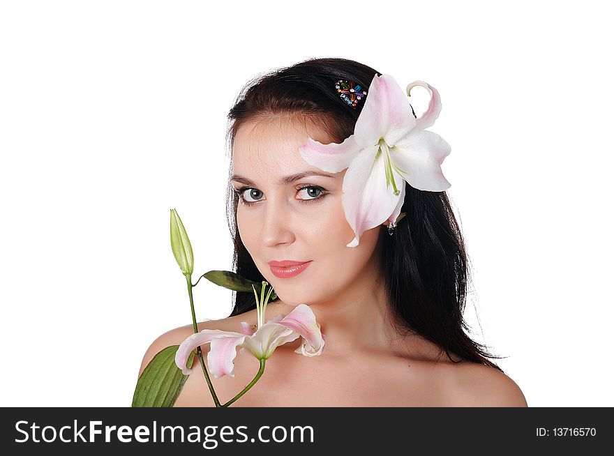 Young charming brunette with beautiful delicate white lily in the hands