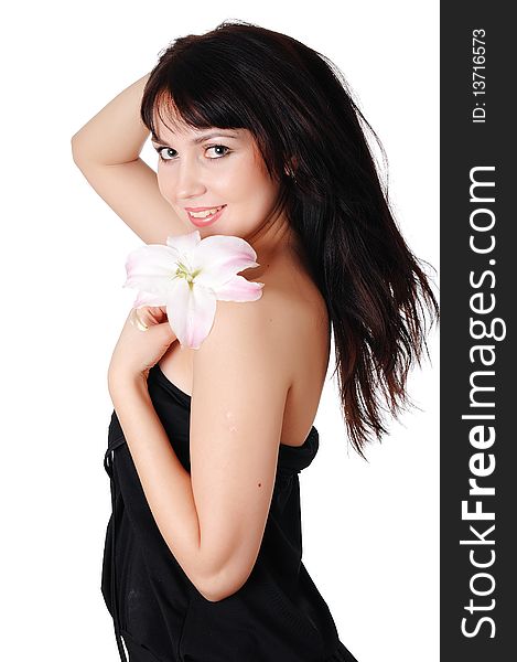 Young charming brunette with beautiful delicate white lily in the hands