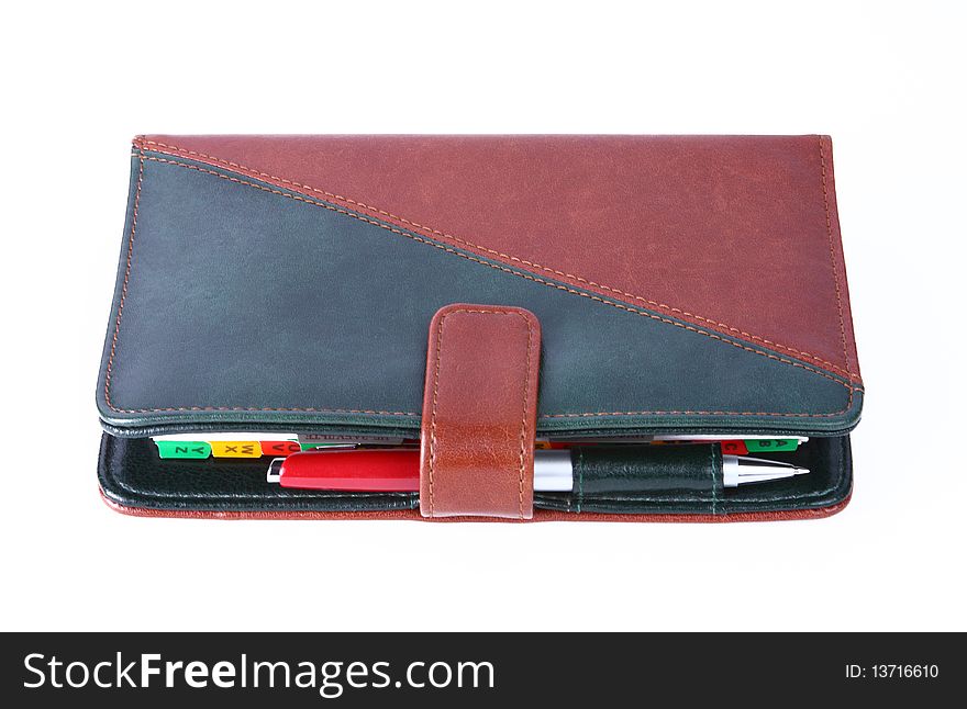 Leather office organizer on blue with a red pen. Leather office organizer on blue with a red pen