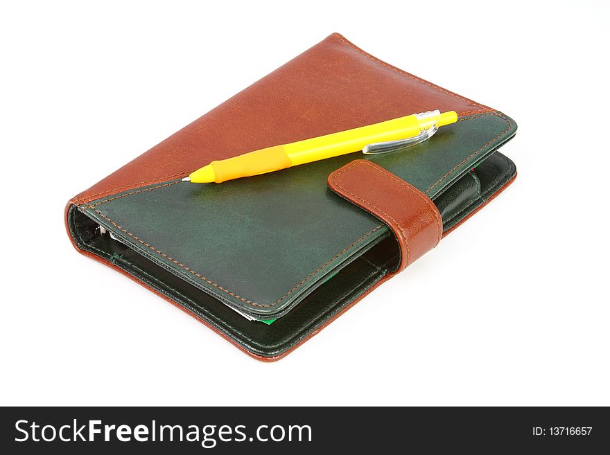 Leather office organizer isolated with a yellow pen. Leather office organizer isolated with a yellow pen