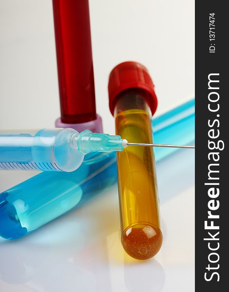 Glass test tubes filled with liquid for an experiment in a science research lab. Search and testing of serum against the virus Covid-19