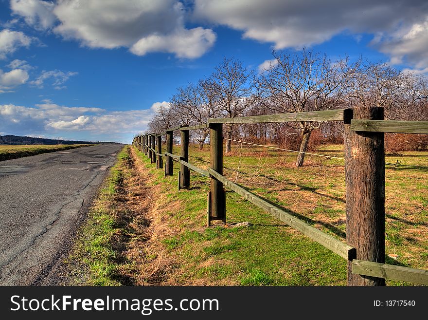 A country road next to meadow. A country road next to meadow