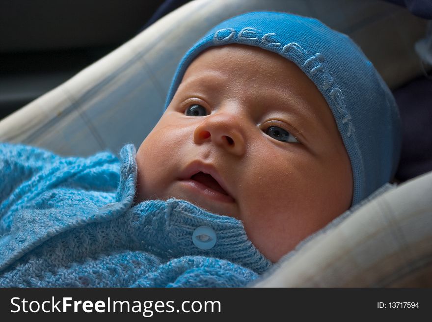 Happy newborn in car seat