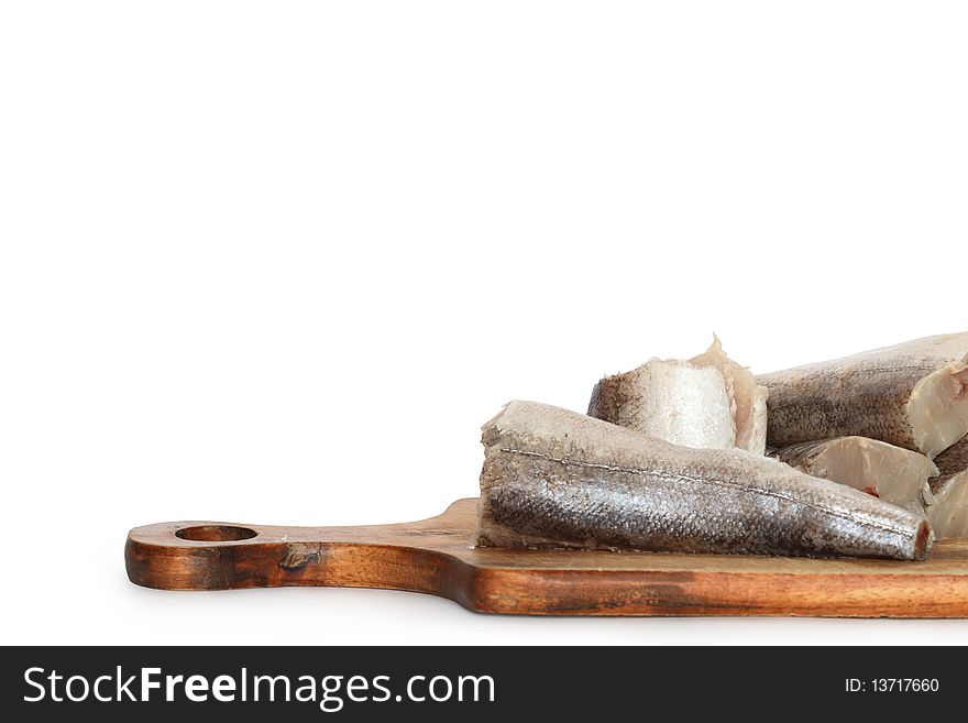 Sliced raw fish lying on wooden cutting board. Isolated on white background with clipping path. Sliced raw fish lying on wooden cutting board. Isolated on white background with clipping path