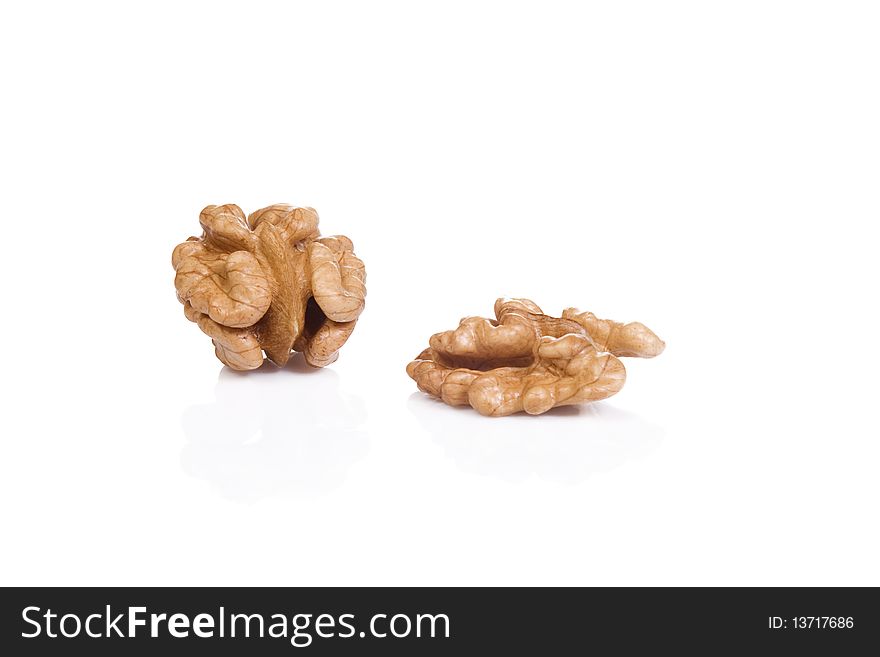 Two isolated walnuts at white