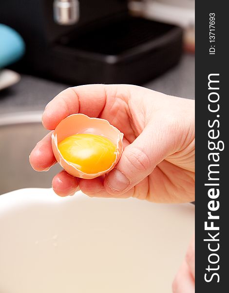 Person is using a egg in the kitchen