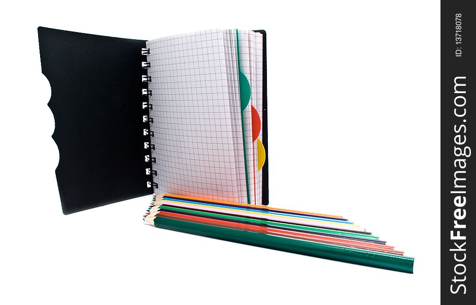 Notebook with a spring and pencils on a white background