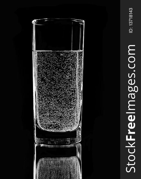 Glass with water on a black background