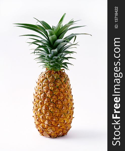 A ripe pineapple on a white background