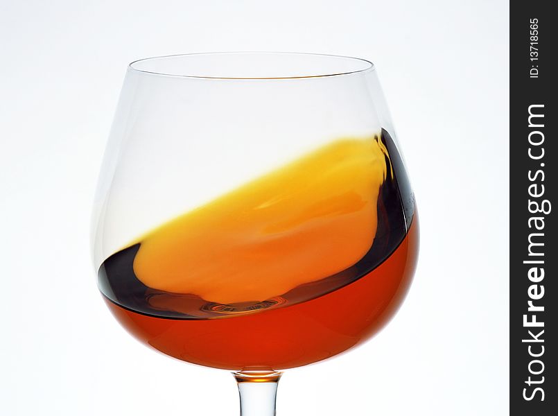 A glass of brandy on a white background