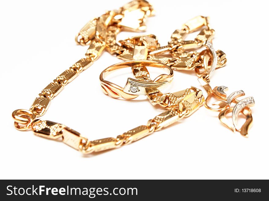 The isolated photo of golden chain, ring and a pendant. The isolated photo of golden chain, ring and a pendant