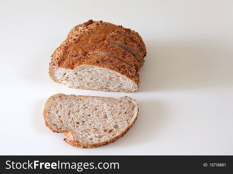 Fresh Baked Bread On Witer Background, one sliced