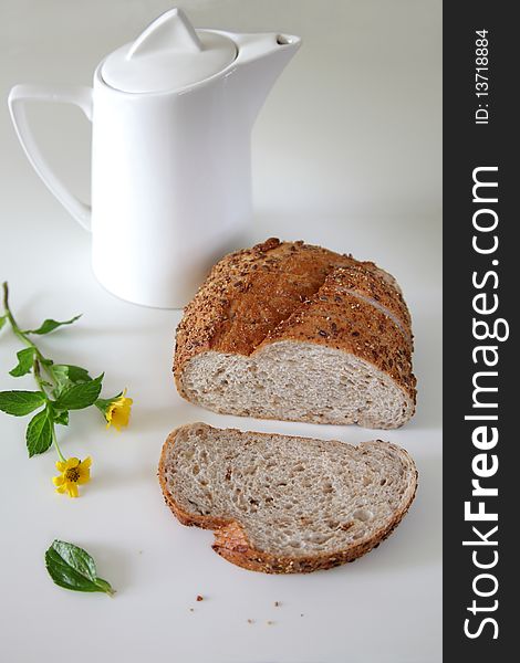 Fresh Baked Bread On Witer Background, one sliced