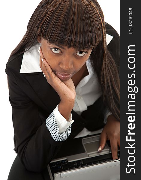 Young black female lawyer with face in hand on laptop looking up