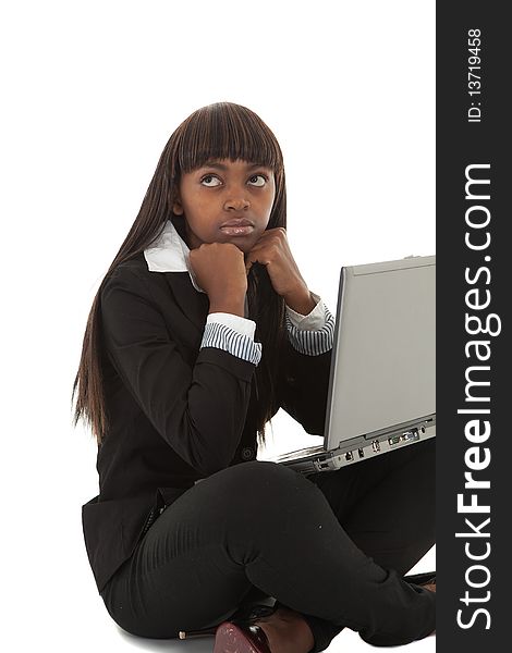 Young black female executive looking tired with face in hands on laptop