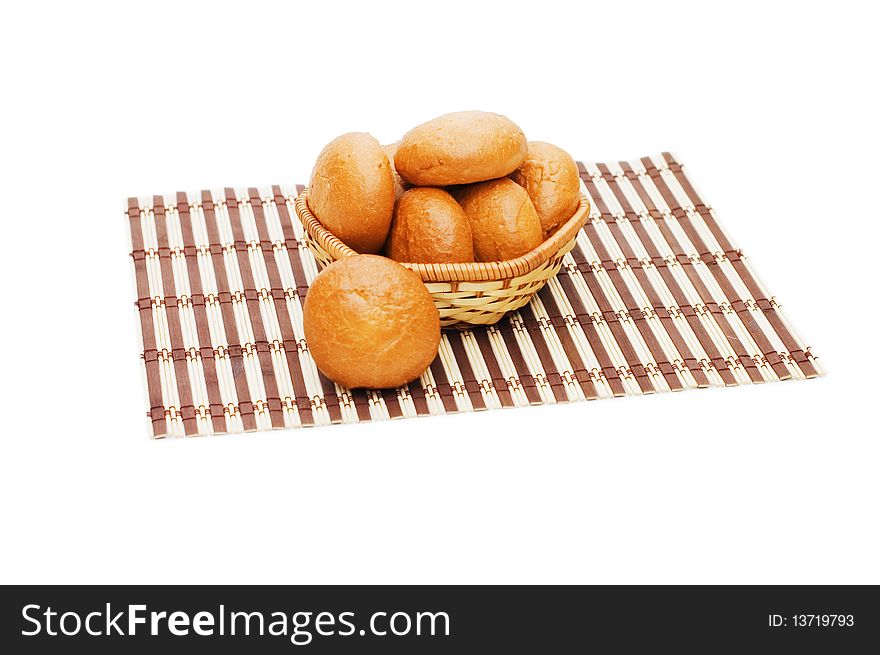 Rolls in a wattled basket isolated on white