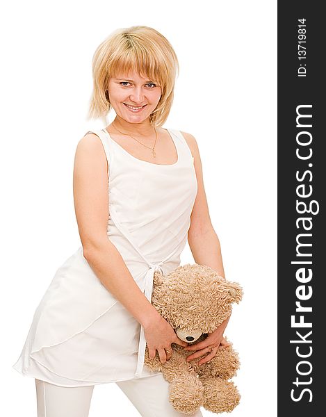 The beautiful girl with a toy bear isolated over white
