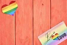 Postcard Love Is Love And A Heart With A Rainbow Of LGBT, On Wooden Texture Background Color Living Coral Royalty Free Stock Photos Postcard Love Is Love And A Heart With A Rainbow Of LGBT, On Wooden Texture Background Color Living Coral Royalty Free Stock Photos