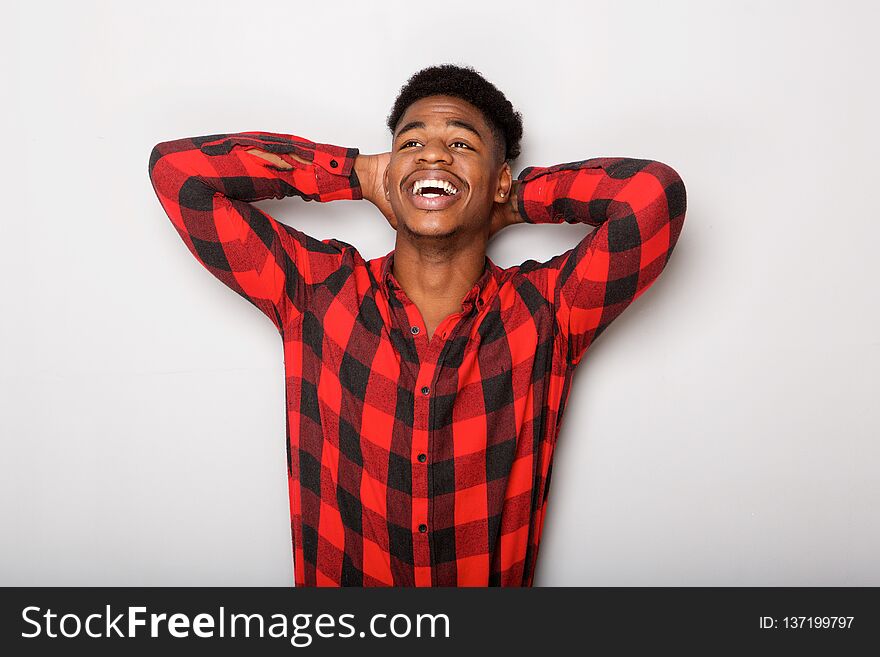 Carefree young african american man with hands behind head