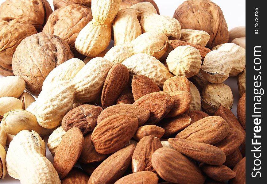 Peanuts, almonds, pistachios, walnuts on white background