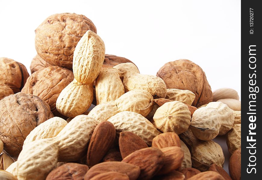 Peanuts, almonds, pistachios, walnuts on white background