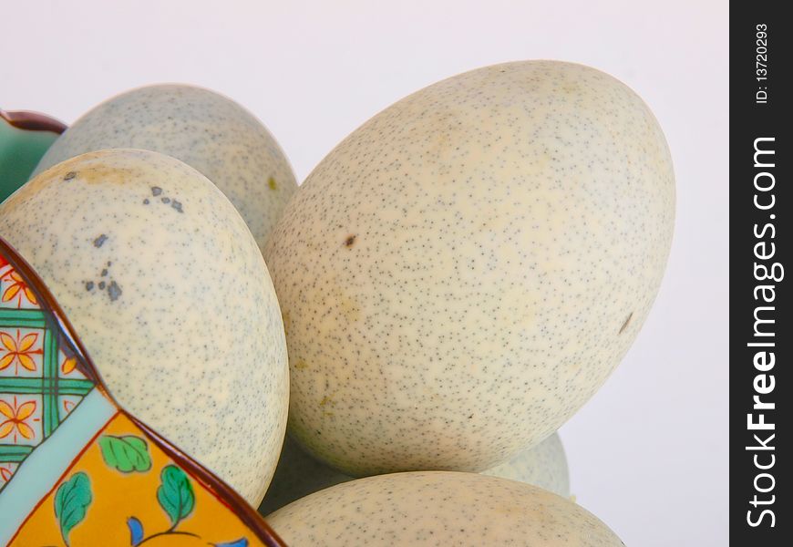 Preserved duck eggs. Close up on white background