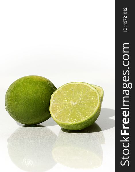 Limes cut in half isolated on a white background