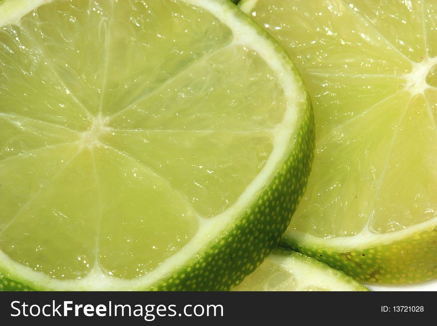 A background of limes sliced in half