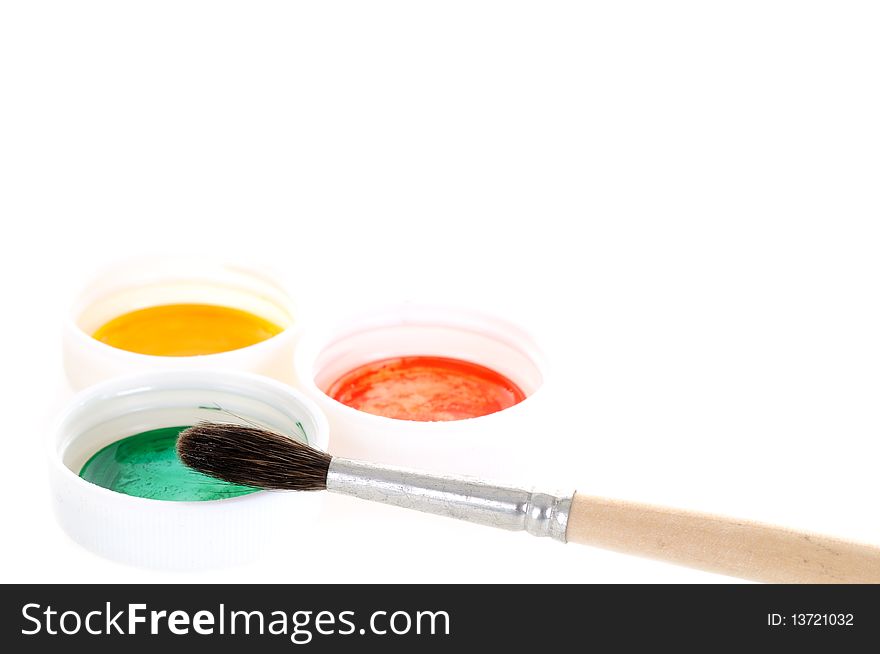 Small brush with three paint covers on white background. Small brush with three paint covers on white background