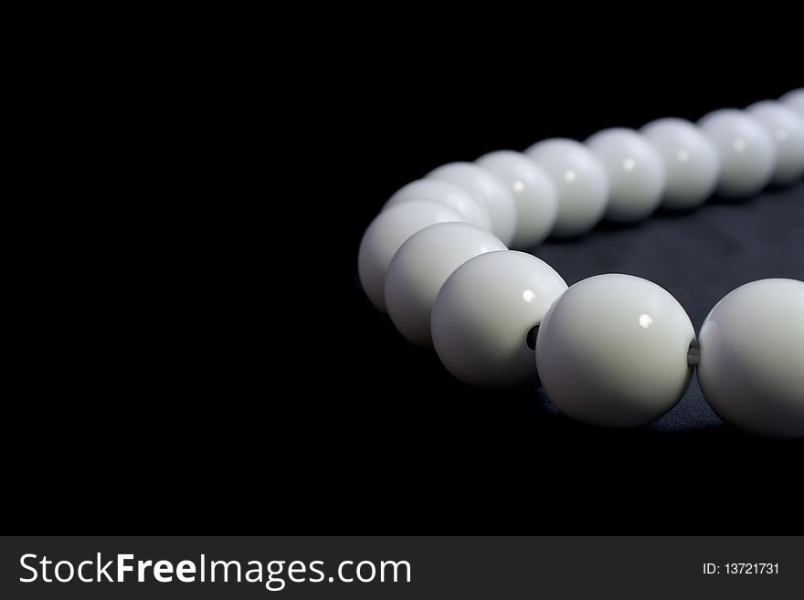 Chain from white spheres on black background