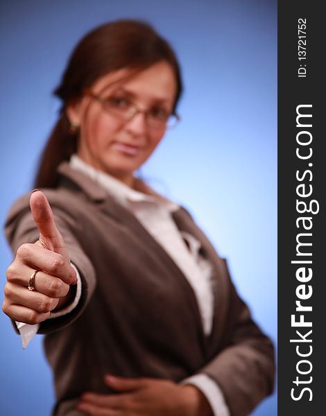 Young businesswoman showing thumb up. Young businesswoman showing thumb up